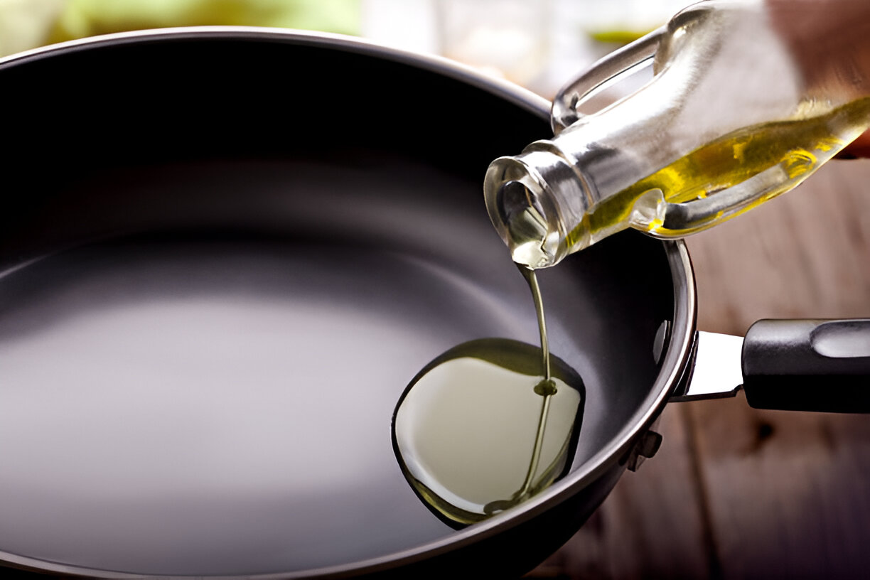 Cooking oil being added to skillet