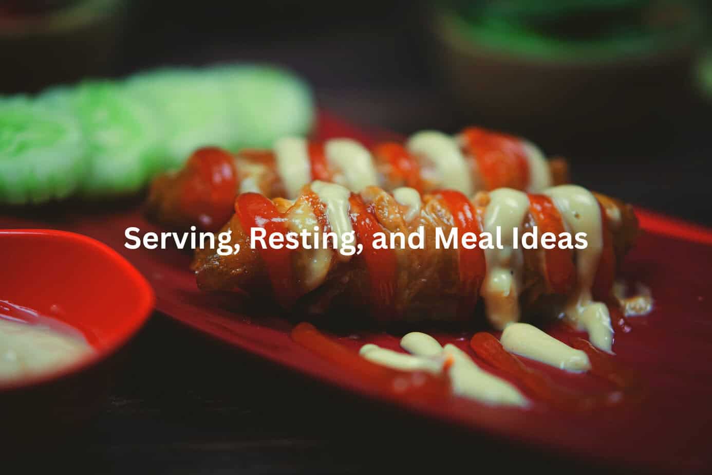 Savory cooked meat with a rich sauce, topped with white chunks, surrounded by bright red tomatoes on a vibrant red plate.