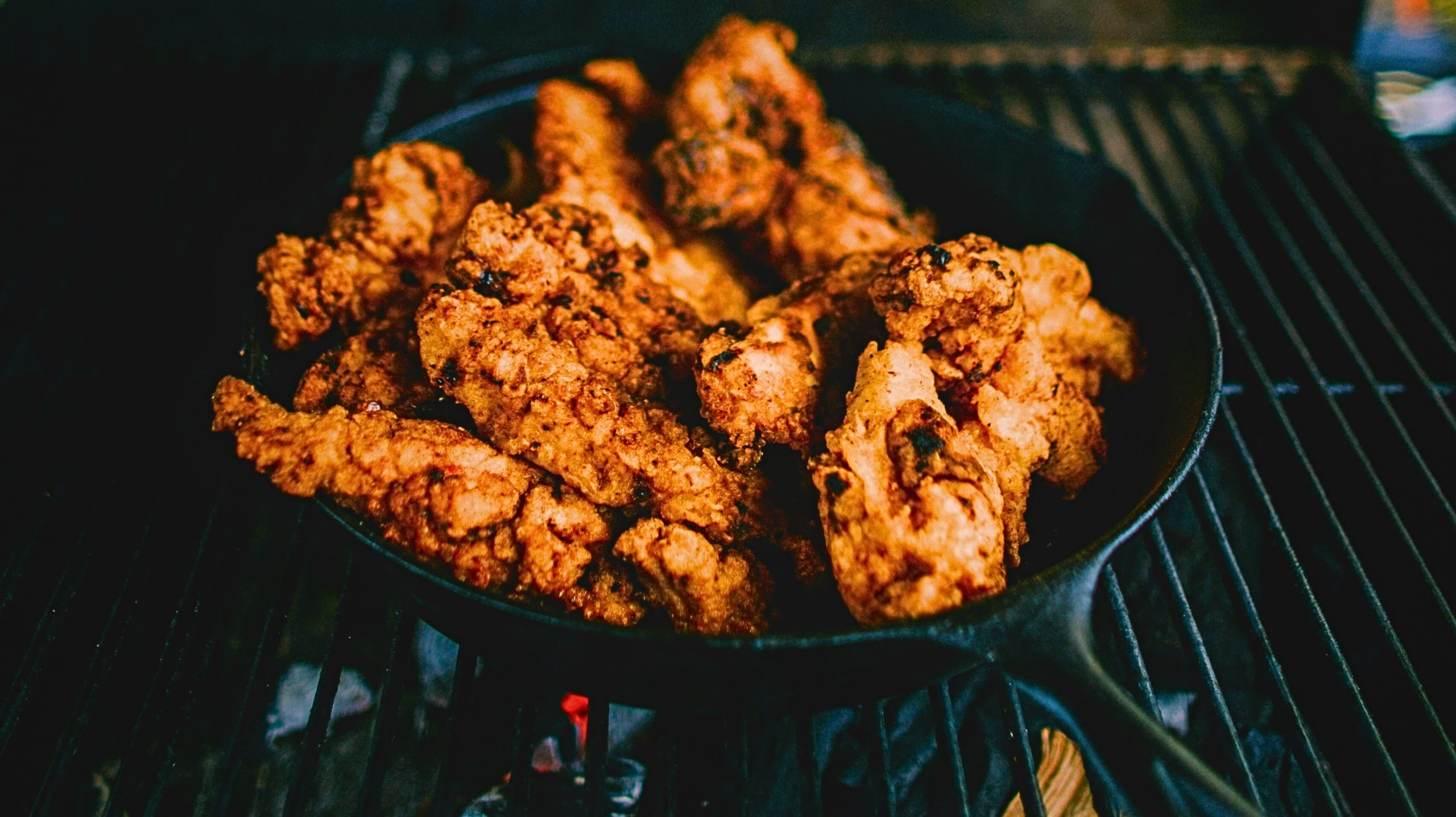 Fried chicken in a cast iron skillet, showcasing various chicken sausage uses in delicious dishes Credit: unsplash.com (photo by Ivana Cajina)