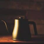 Black kettle on brown wooden table
