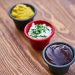 Close-up of creamy, tangy, and smoky sauces ready to elevate your chicken sausage platter with easy homemade dip ideas. Credits: pexels.com (Photo by Engin Akyurt)