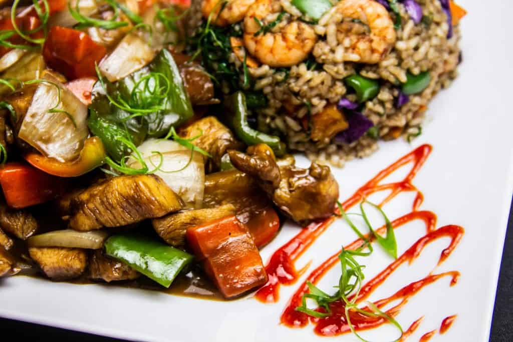 A steaming bowl of chicken sausage gumbo with shrimp, packed with okra, peppers, and tender meat, ready to be served over fluffy white rice. Credits: pexels.com (Photo by Horizon Content)