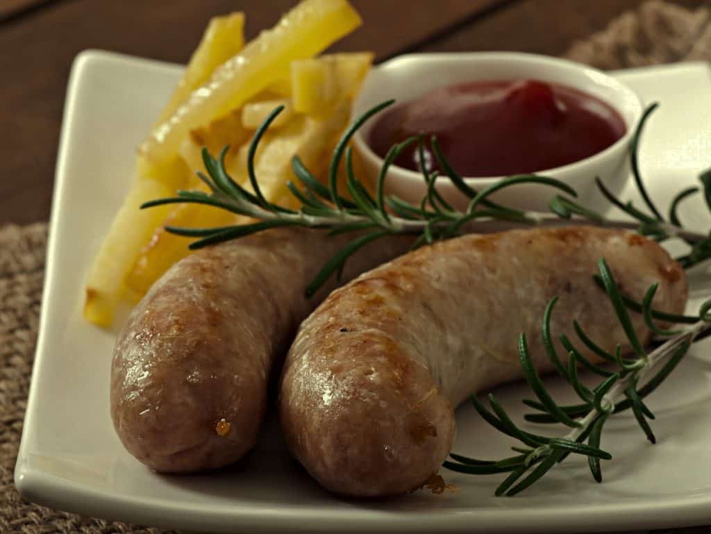 Chicken sausages grilled with a side dish of french fries
