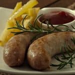 Chicken sausages grilled with a side dish of french fries
