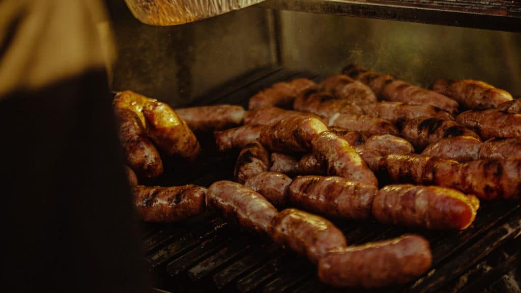 Juicy jalapeno chicken sausages sizzling on the grill, ready to be cooked to perfection and packed with flavor.
