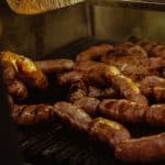 Juicy jalapeno chicken sausages sizzling on the grill, ready to be cooked to perfection and packed with flavor.
