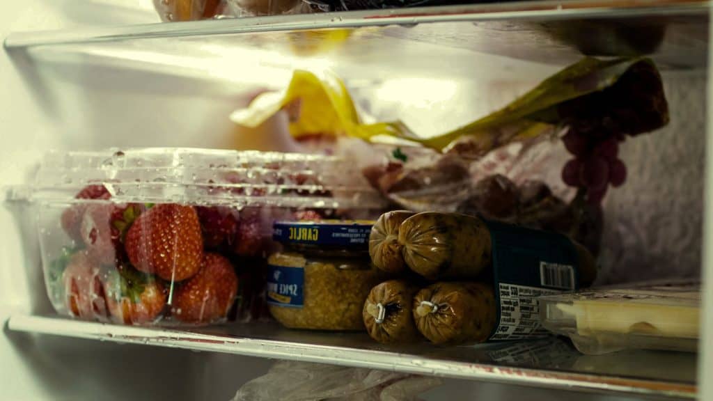 Well-organized fridge featuring chicken sausages, inviting to consider: how long can chicken sausage be in the fridge?