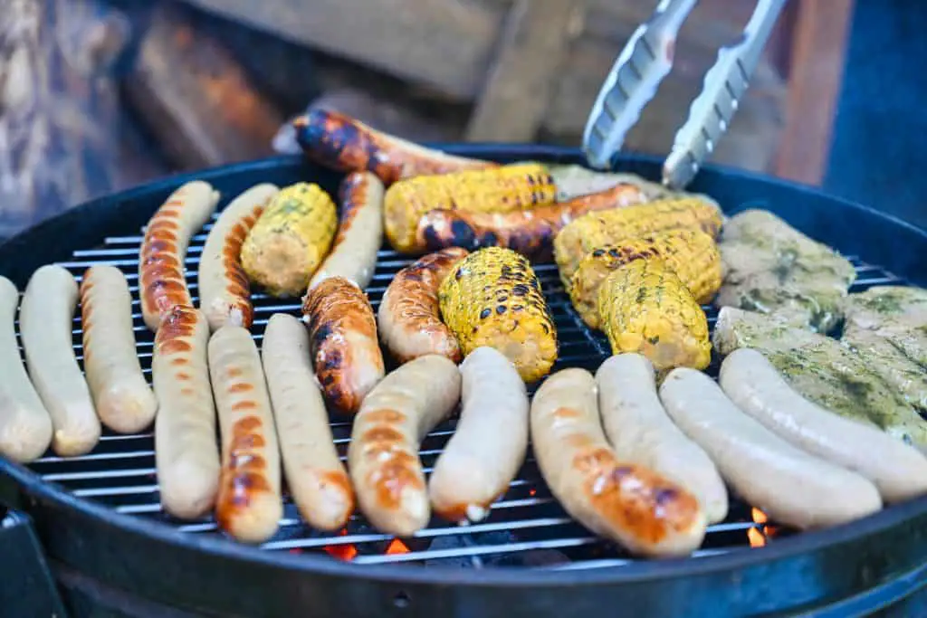 How to cook Trader Joe's chicken sausage alongside grilled vegetables and seasoned meat over hot coals
