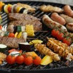 Grilling guide showing how to cook raw chicken sausage on grill alongside skewered veggies and meat cuts.