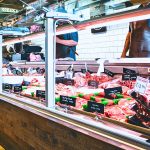 A butcher shop display featuring various meats, including options to buy chicken sausage online.