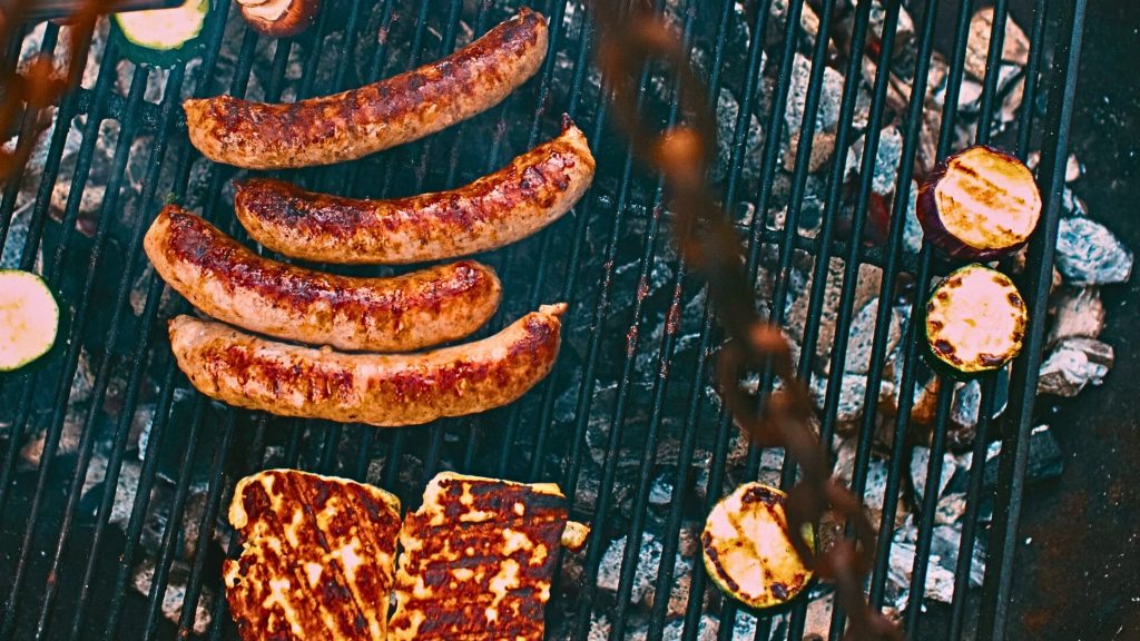Cook The Restaurant's Food at Home 37 Grilled chicken sausages alongside zucchini and cheese, highlighting versatile chicken sausage uses in outdoor cooking. Credit: unsplash.com (photo by Markus Spiske)