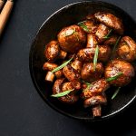 A bowl of sautéed mushrooms garnished with herbs, perfect for a Chicken Sausage Veggie Bake. Credit: unsplash.com (photo by Alex Bayev)