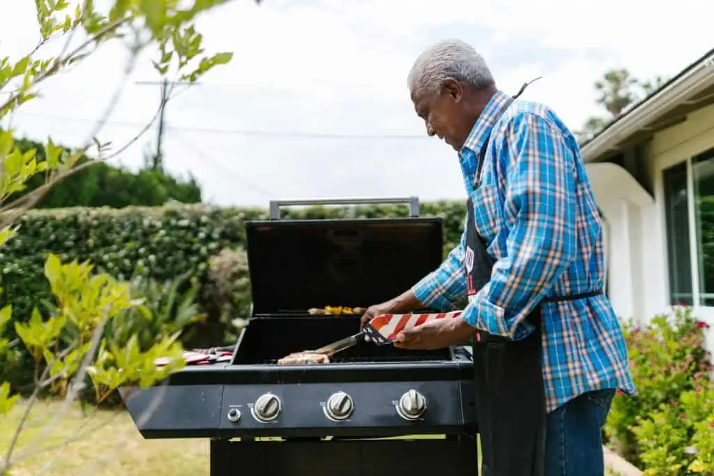 Cut-Up Chicken Sausage: Simple Cooking Method 3 A man grilling outdoors, preparing food, demonstrating techniques for how to cook chicken sausage cut up.