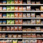 Shelves filled with a variety of chicken sausage products at a Walmart supermarket.