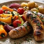 grilled chicken sausage with vegetables on a healthy plate
